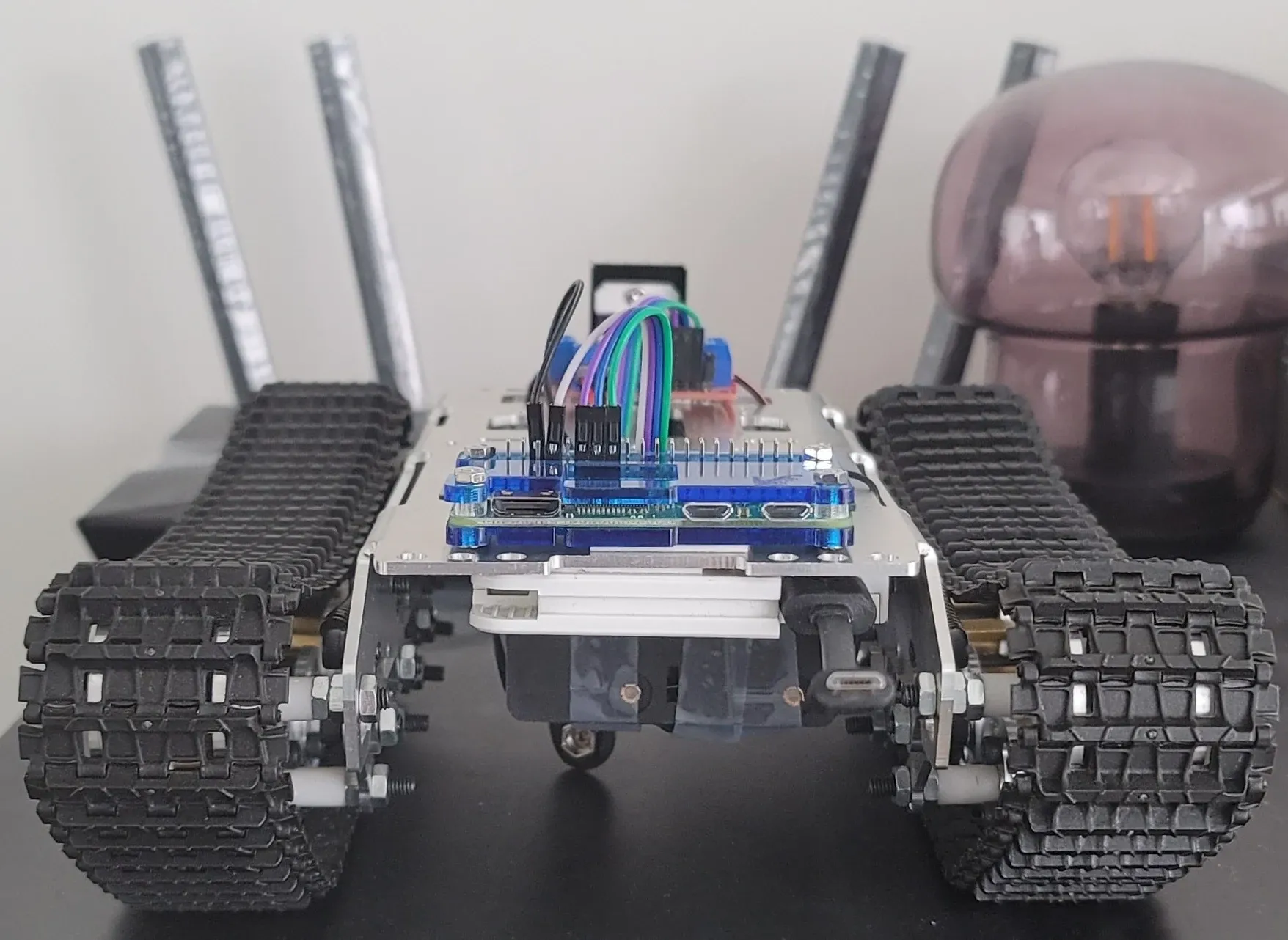 Raspberry Pi tank robot with rubber tracks on a desk